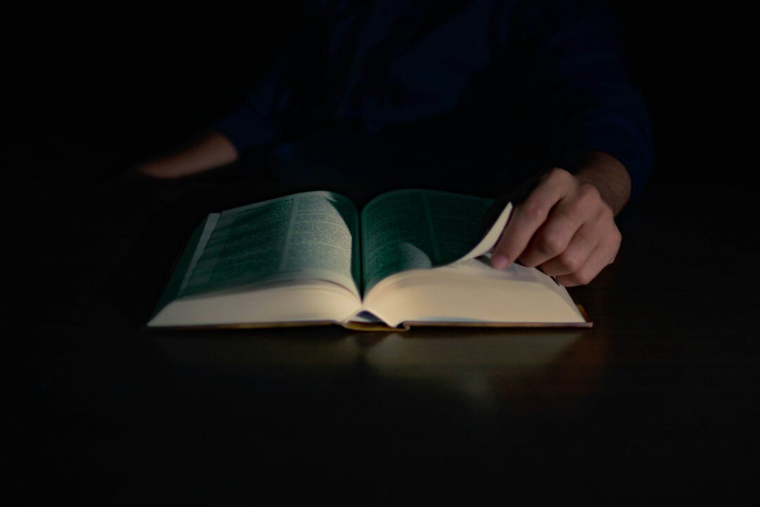 person reading book at night